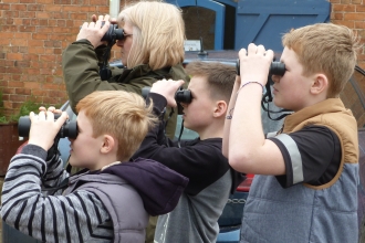 Children with binoculars c. Claire Huxley