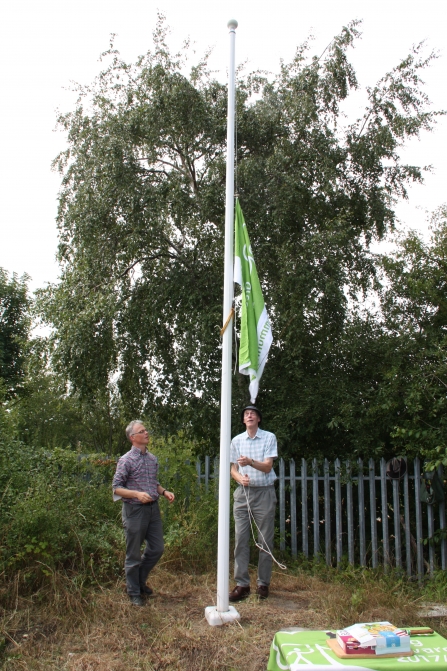 Green flag being raised at New Ferry Butterfly Park c. Richard Ash