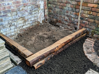 photograph of a planter with soil in before it has been planted 