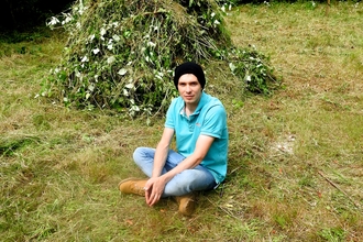 Wild Wellbeing volunteer resting by hay stack