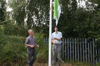 Green flag being raised at New Ferry Butterfly Park c. Richard Ash