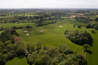 Aerial view of a Cheshire Wildlife Trust nature reserve, looking down over fields, woodlands and pond scapes.