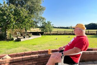 Legacy donor David Aldred relaxing in his garden