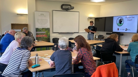 Representatives from community groups gather at a networking event.