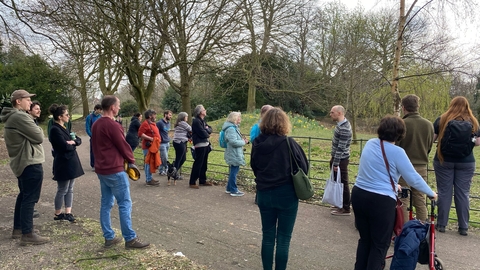 Image of 20 people on a guided tree ID walk in a park in Birkenhead.