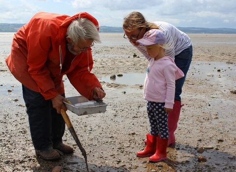 volunteer showing off rock pool finds
