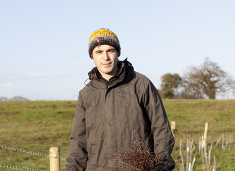 Andy stands by newly planted trees