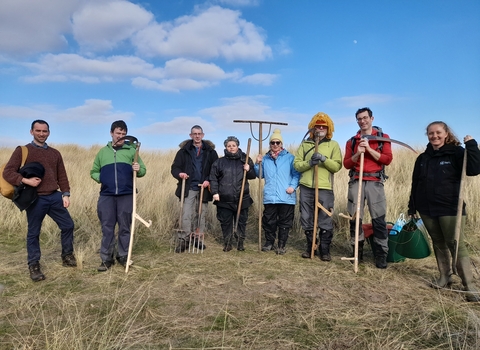 Groups of volunteers working at Red Rocks nature reserve